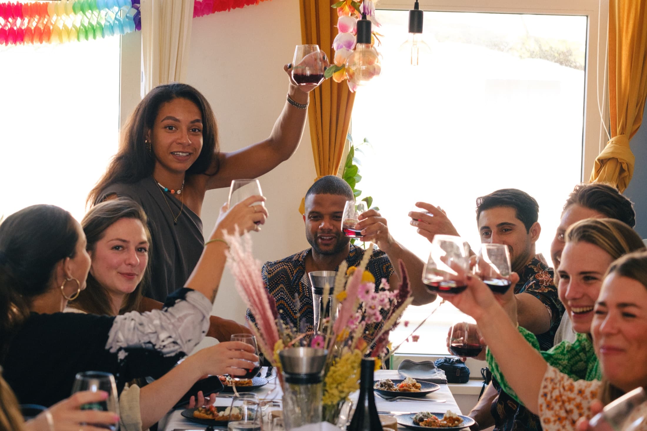 Guests raising a toast at the table during dinner