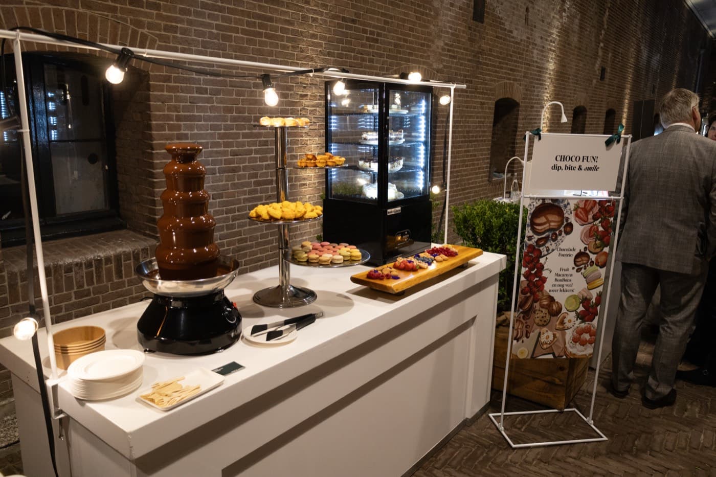 Dessert bar with chocolate fountain, macarons and patisserie