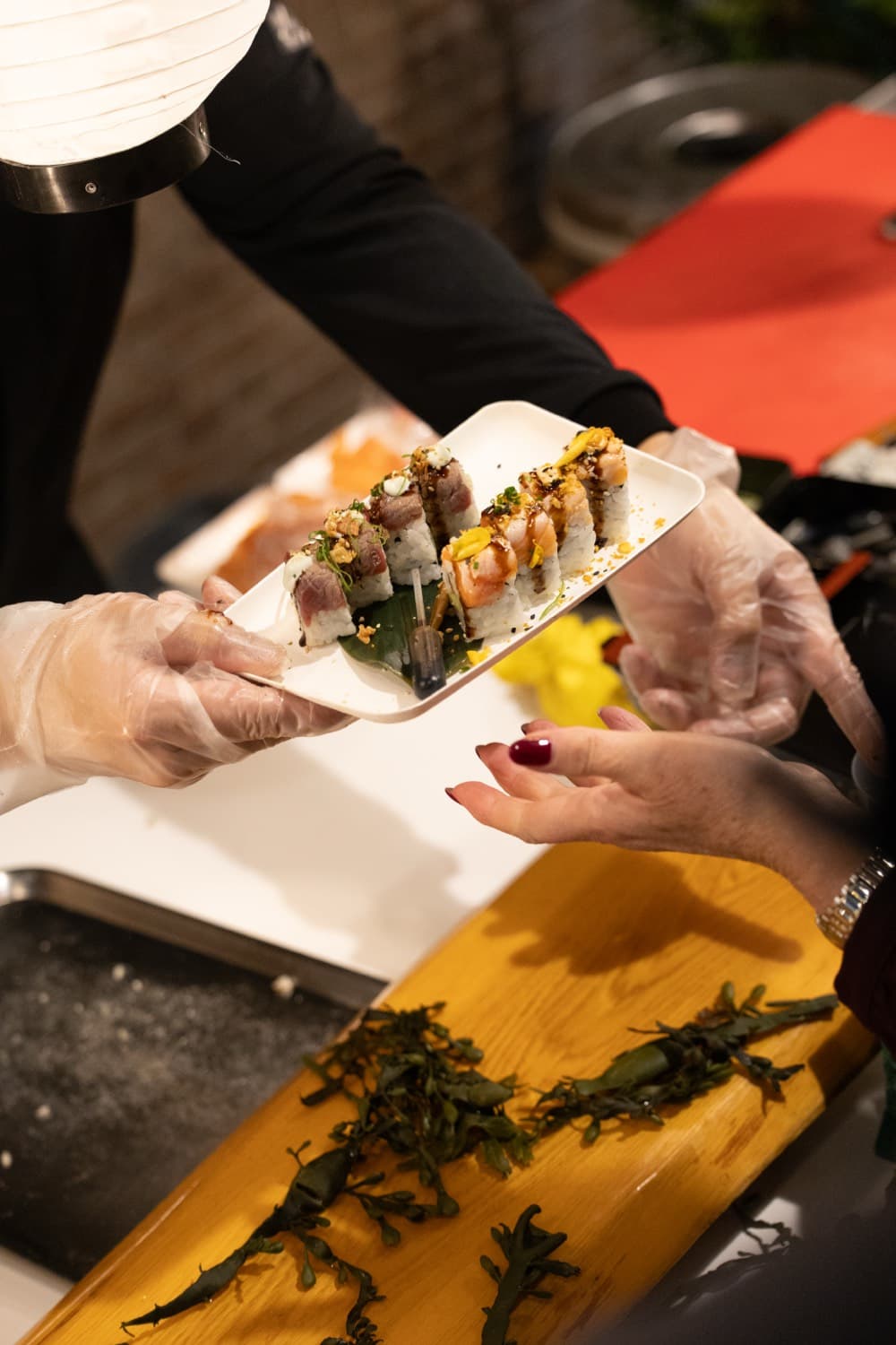 Freshly made sushi rolls handed over the counter