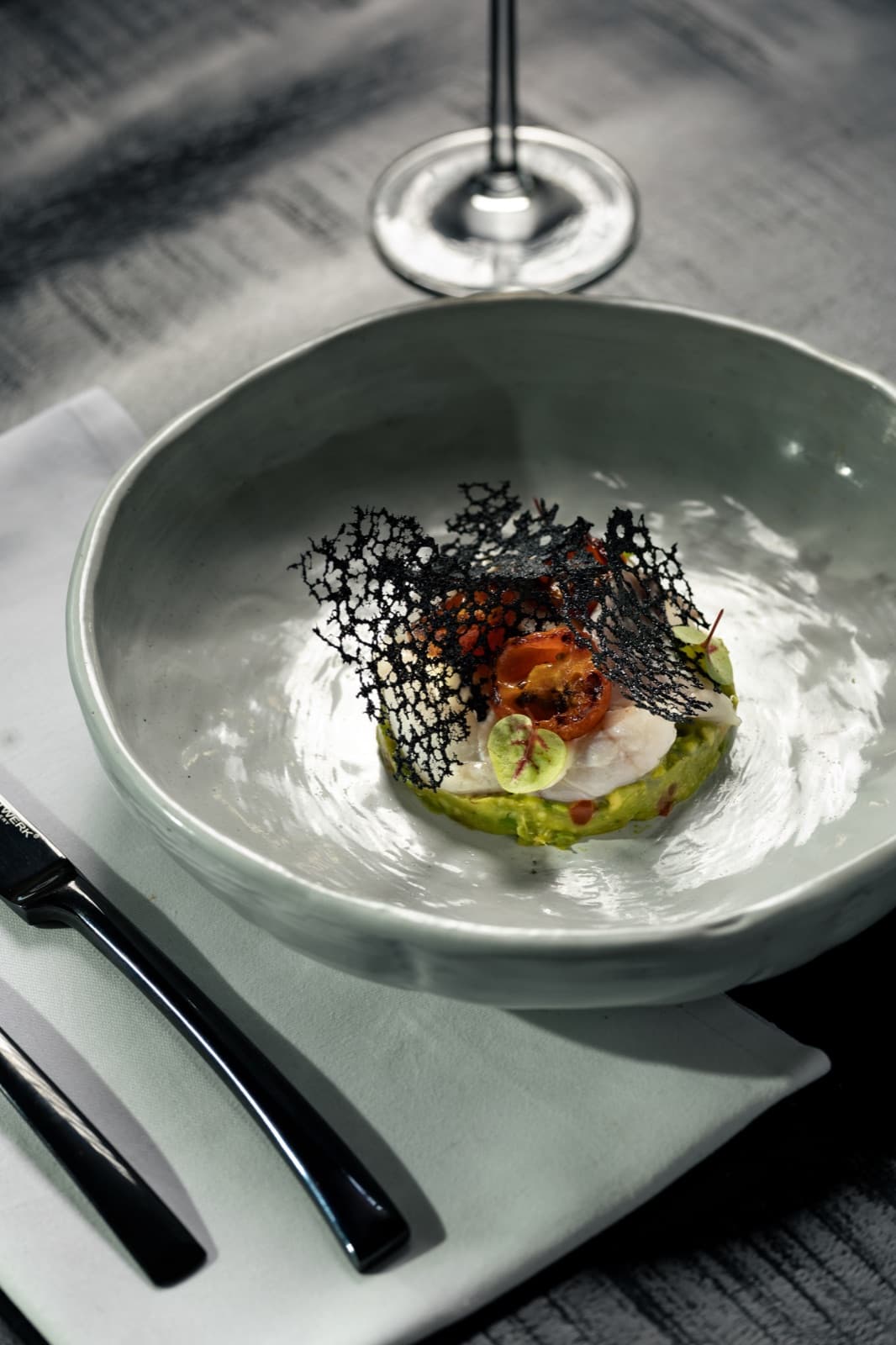 Ceviche with avocado and a squid-ink crisp