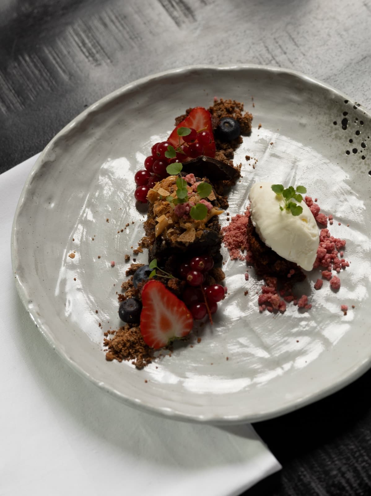 Chocolate dessert with red fruit and crème fraîche