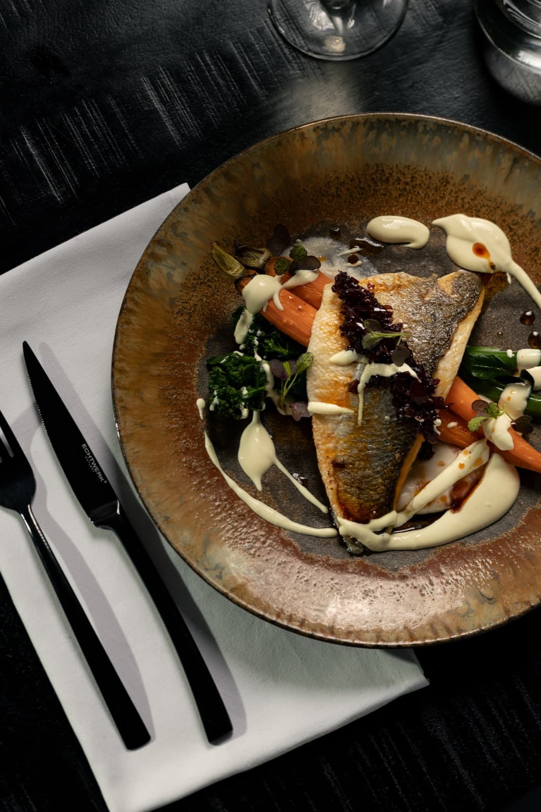 Pan-fried sea bass fillet with young carrots