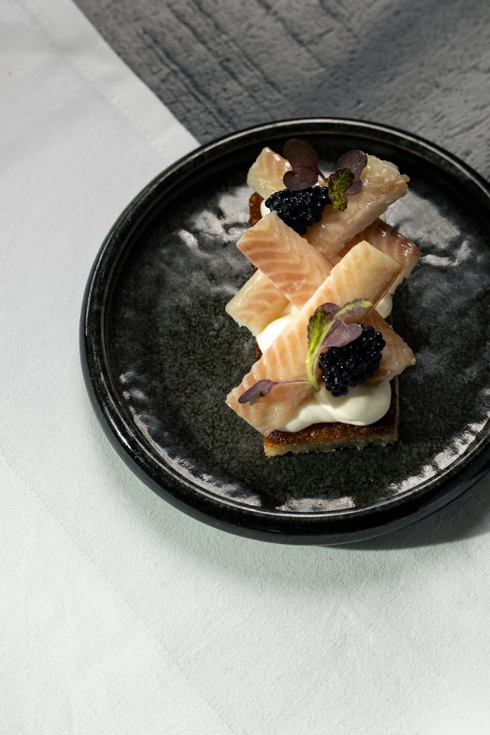 Brioche with eel and caviar, served as a bite