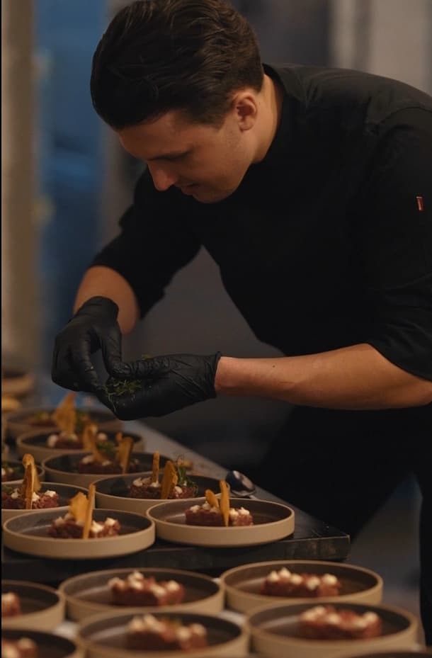 Chef finishing a dish in the kitchen